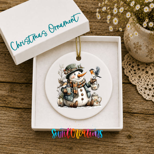 snowman with a lantern and winter birds ceramic Christmas ornament presented in a gift box