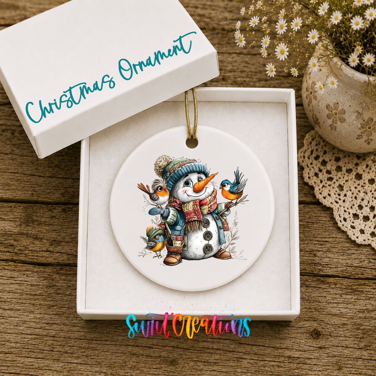 snowman in a blue hat with colorful winter birds ceramic Christmas ornament presented in a gift box