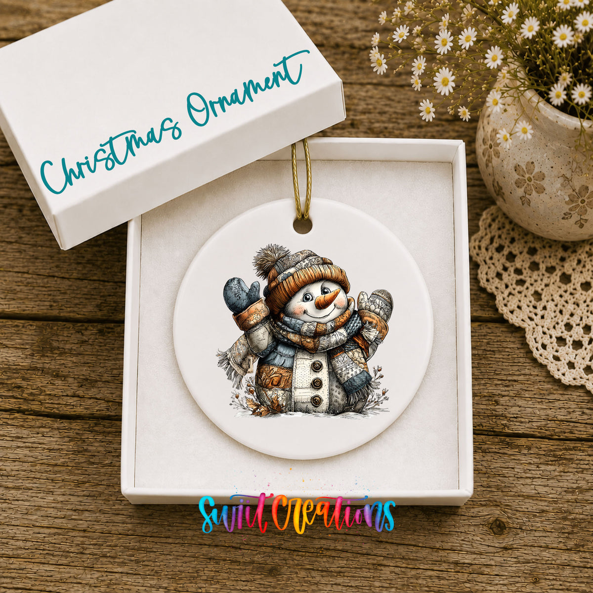 cheerful snowman in a knit hat and blue mittens ceramic Christmas ornament presented in a gift box