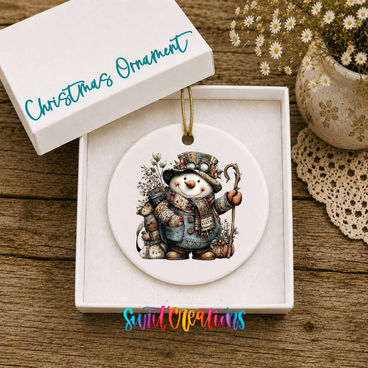 snowman with a walking stick and winter greenery ceramic Christmas ornament presented in a gift box