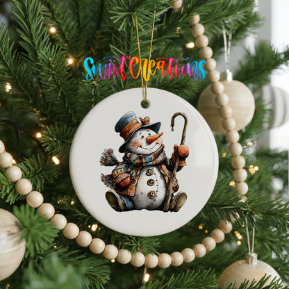 playful snowman in a top hat with a candy cane ceramic Christmas ornament hanging on a green Christmas tree