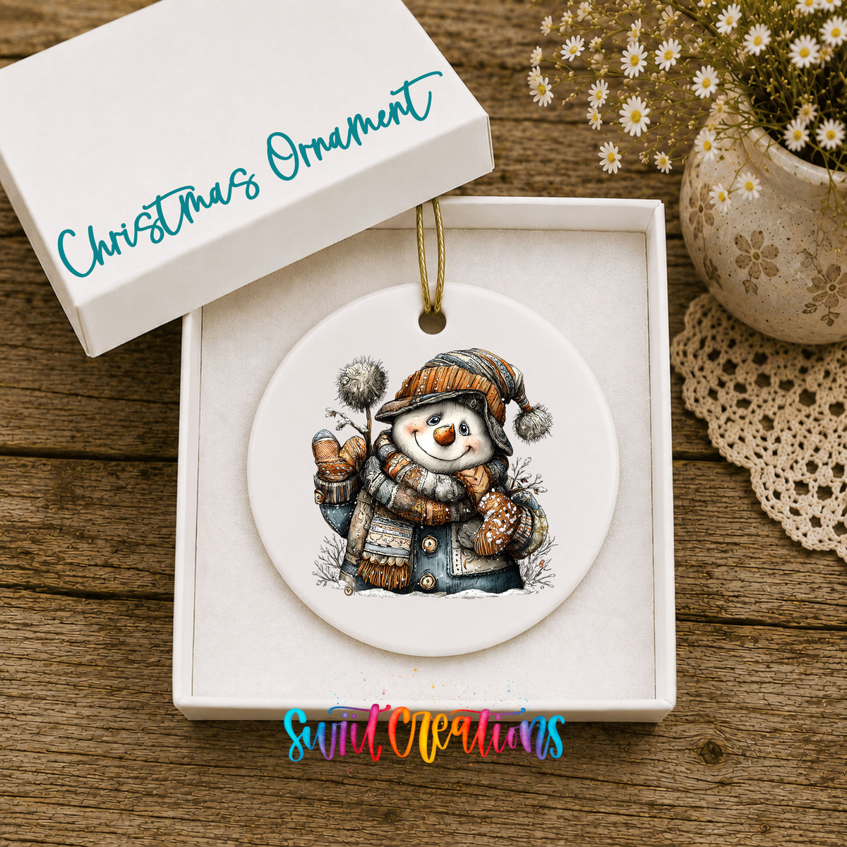 snowman in a striped knit hat and winter mittens ceramic Christmas ornament presented in a gift box