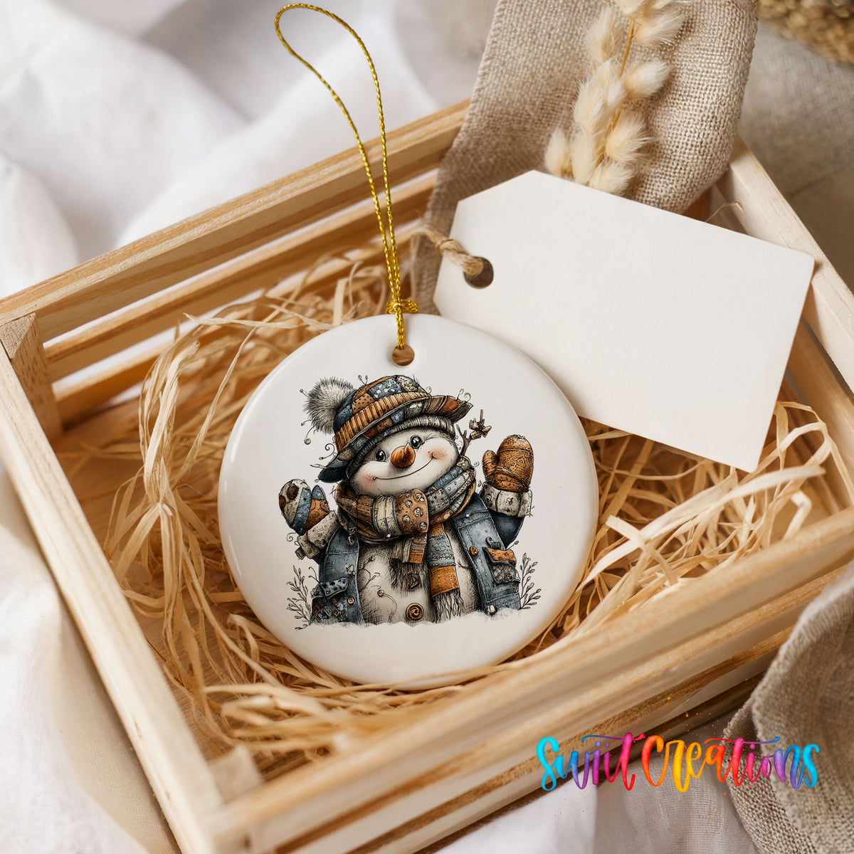 cheerful snowman in a striped knit hat ceramic Christmas ornament displayed in a wooden gift crate