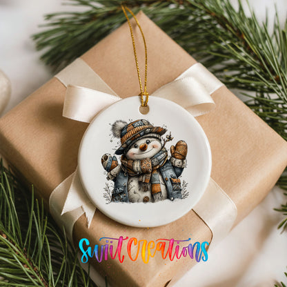 cheerful snowman in a striped knit hat ceramic Christmas ornament displayed on a wrapped Christmas gift