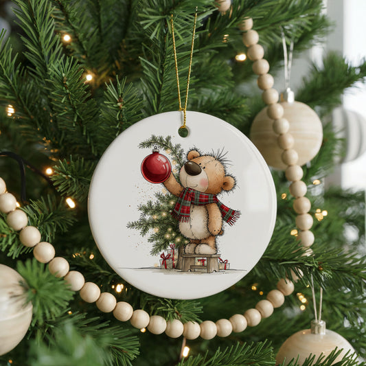 Teddy Bear holding a red ornament, ceramic Christmas ornament, front view