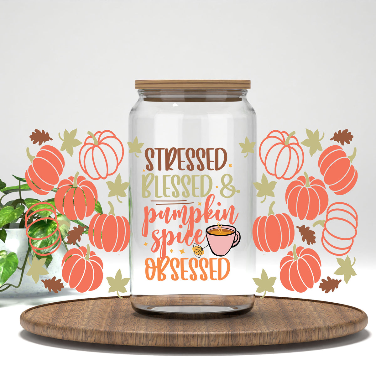 Stressed Blessed and Pumpkin Spice Obsessed UV DTF wrap on a clear glass can