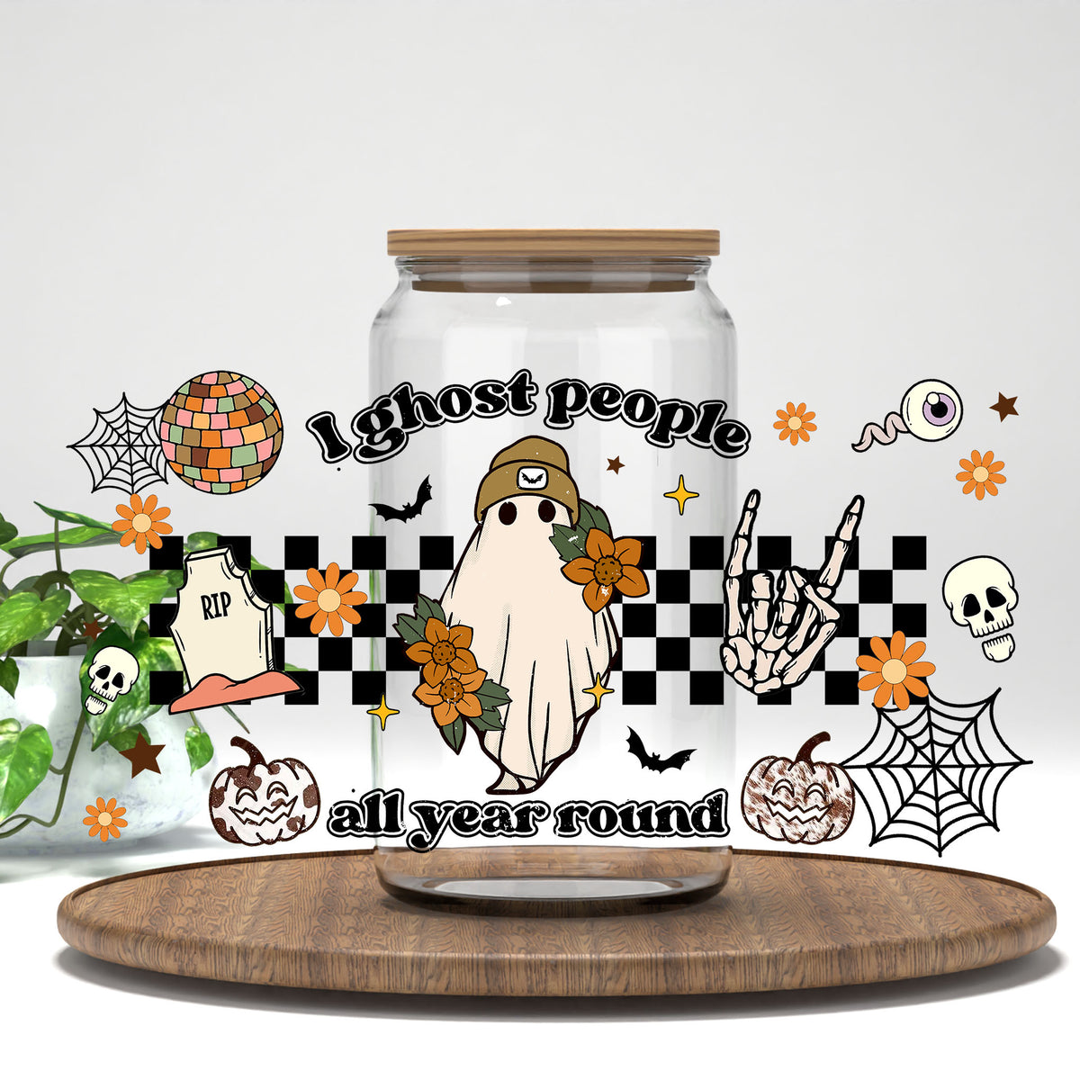 I Ghost People All Year Round UV DTF wrap on a clear glass can