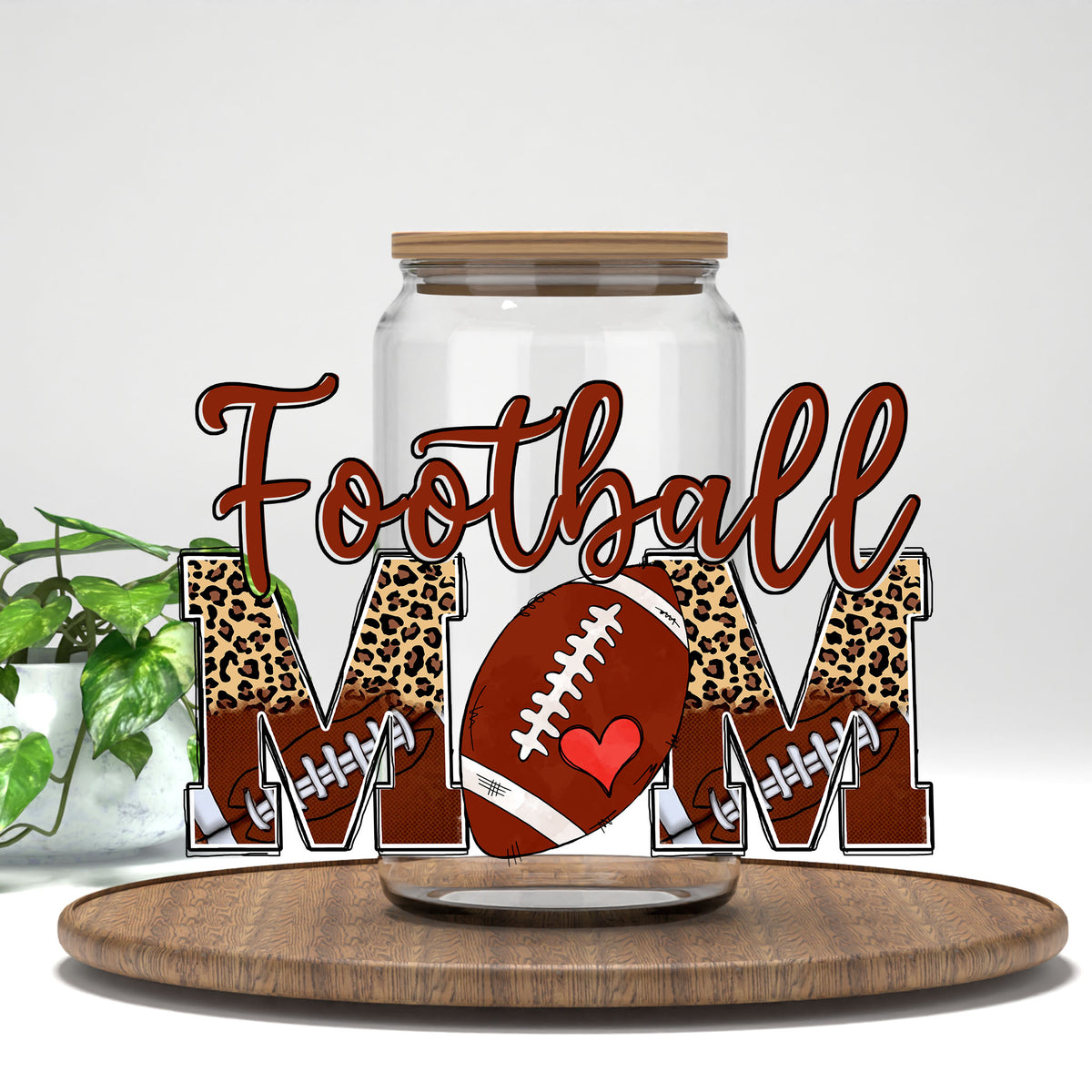 Football Mom UV DTF wrap on a clear glass can
