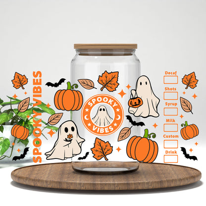 Spooky Vibes ghost coffee badge and pumpkins UV DTF wrap on a clear glass can