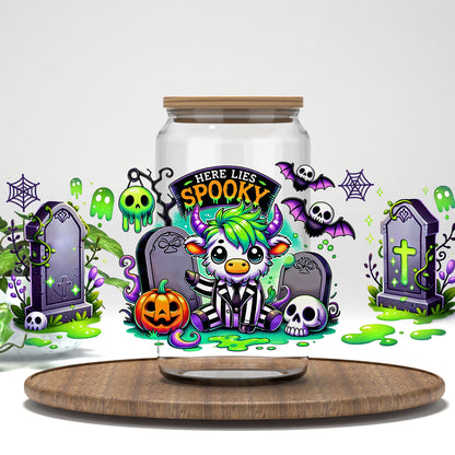 Here Lies Spooky highland cow graveyard UV DTF full wrap on a clear glass can with a bamboo lid