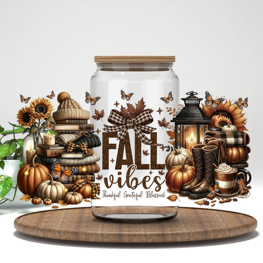 Fall Vibes sweaters, lantern, and sunflowers UV DTF wrap on a clear glass can