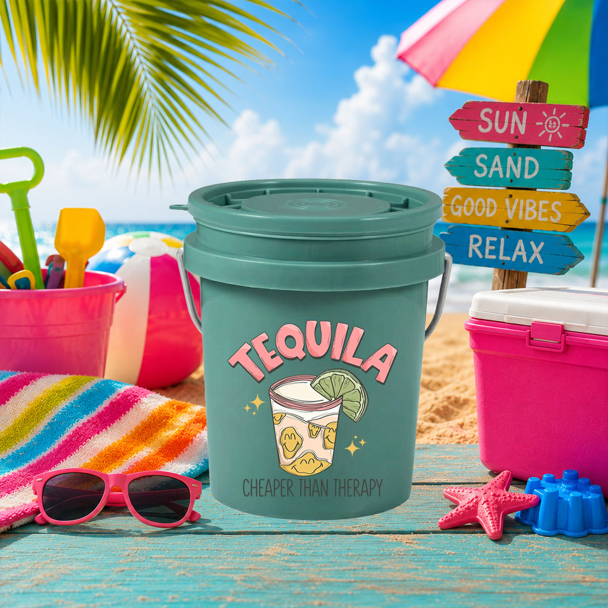 Tequila Cheaper Than Therapy UV DTF transfer on a teal mini bucket on the beach