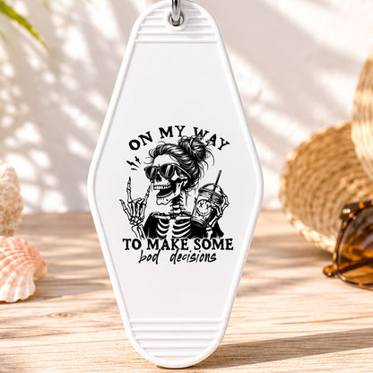 On My Way to Make Some Bad Decisions UV DTF transfer on a white motel keychain with beach decor