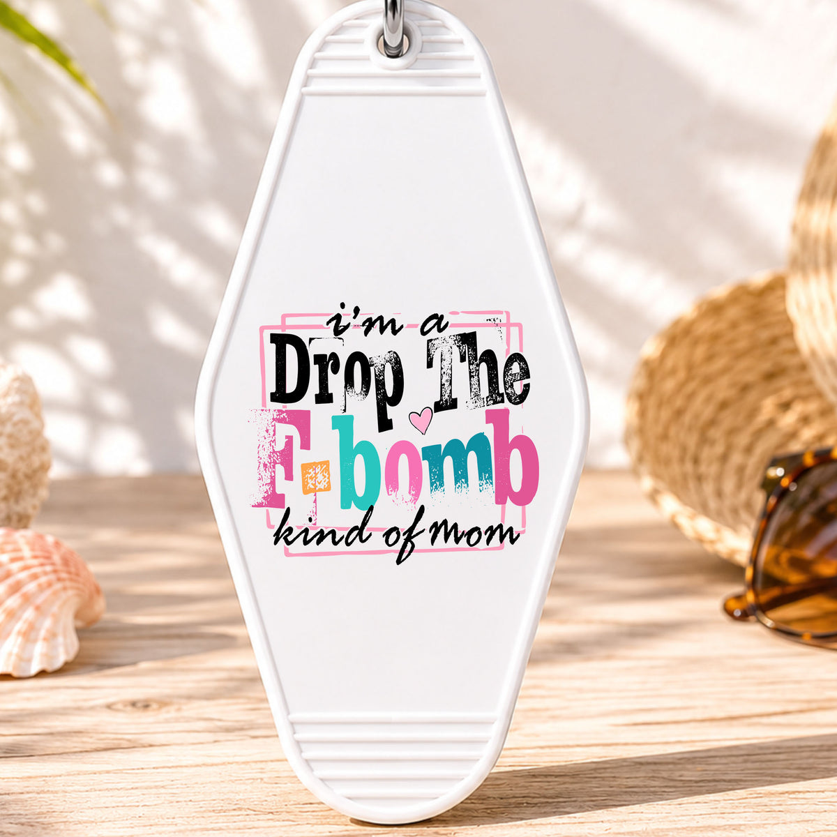 I'm a Drop the F Bomb Kind of Mom UV DTF transfer on a white motel keychain with beach decor
