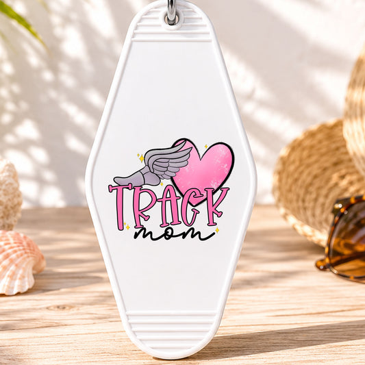 Track Mom UV DTF transfer on a white motel keychain with beach decor