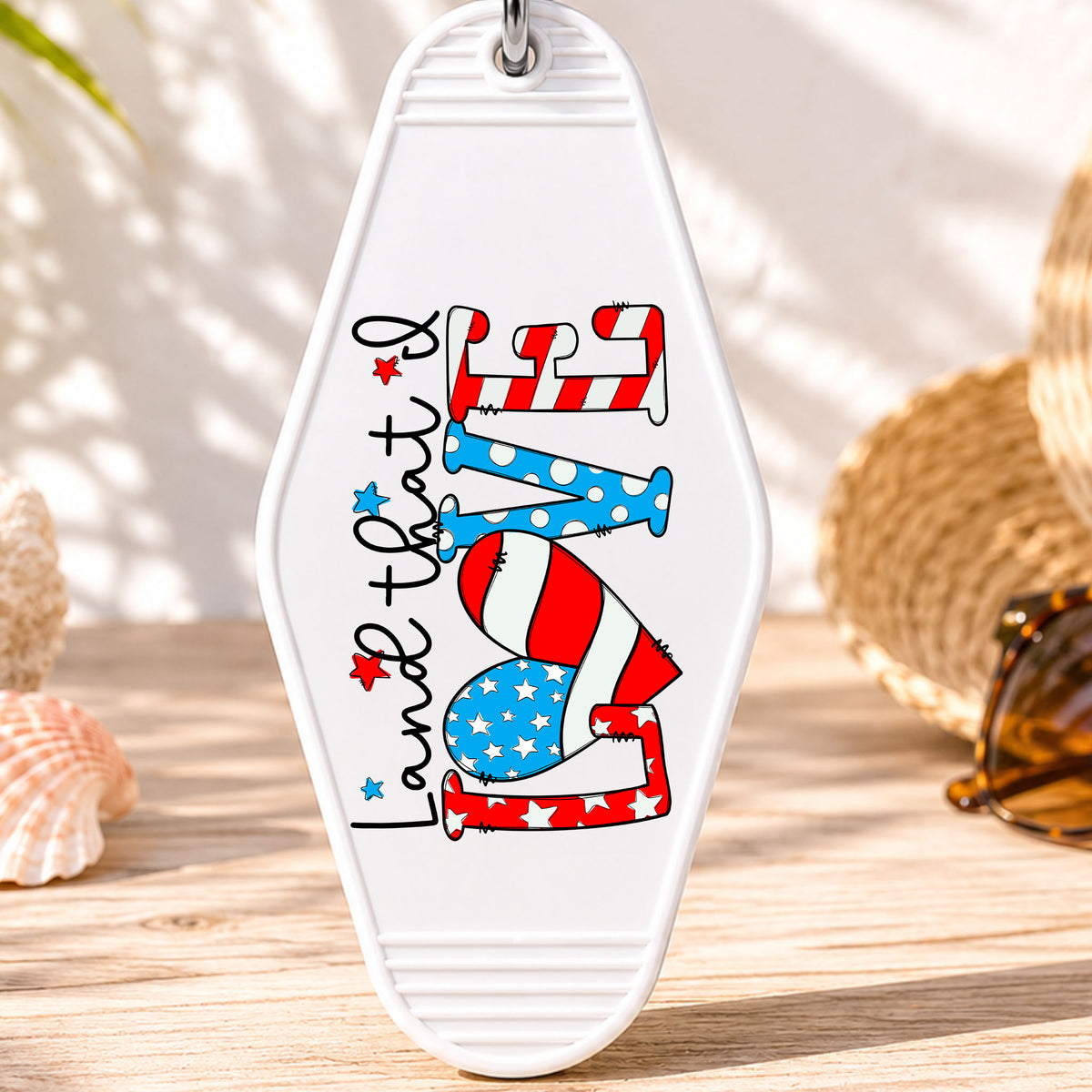 Land That I Love UV DTF transfer on a white motel keychain with beach decor