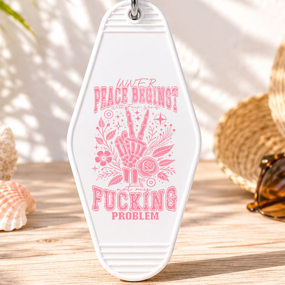 Inner Peace Begins With Four Words UV DTF transfer on a white motel keychain with beach decor