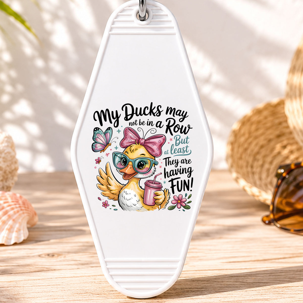 My Ducks May Not Be in a Row UV DTF transfer on a white motel keychain with beach decor
