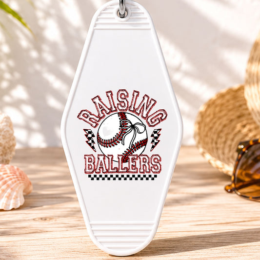 Raising Ballers UV DTF transfer on a white motel keychain with beach decor