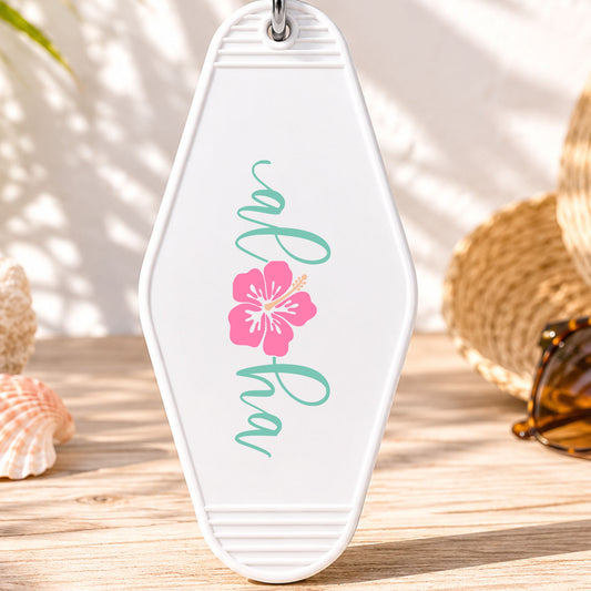 Aloha UV DTF transfer on a white motel keychain with beach decor