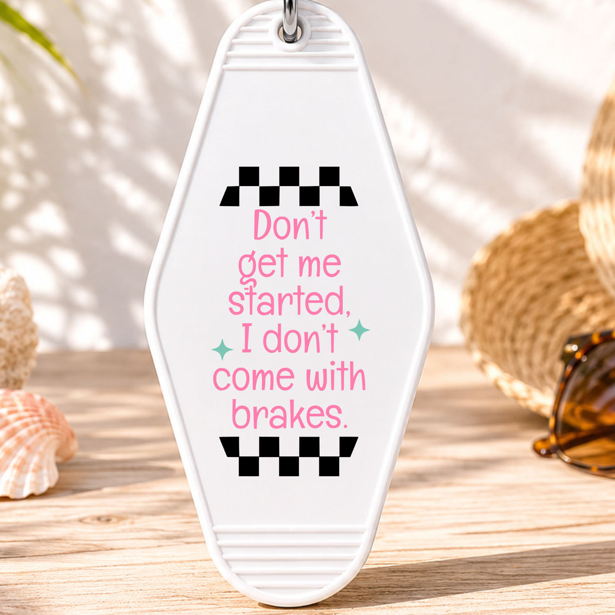 Don't Get Me Started I Don't Come With Brakes UV DTF transfer on a white motel keychain with beach decor