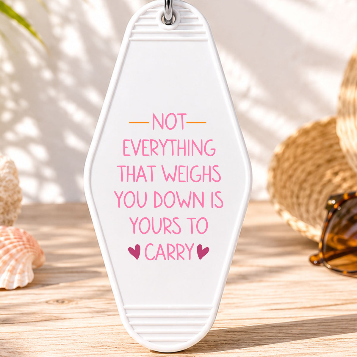 Not Everything That Weighs You Down Is Yours to Carry UV DTF transfer on a white motel keychain with beach decor