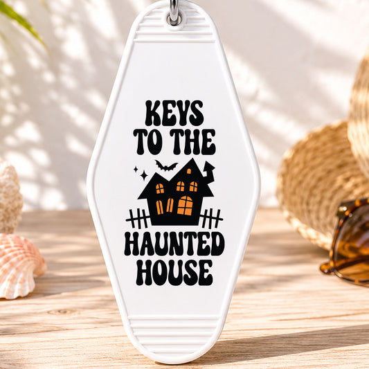Keys to the Haunted House UV DTF transfer on a white motel keychain with beach decor