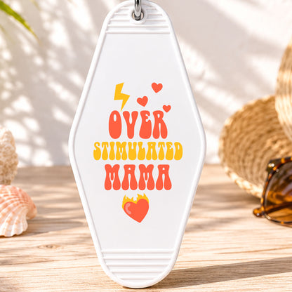 Overstimulated Mama UV DTF transfer on a white motel keychain with beach decor
