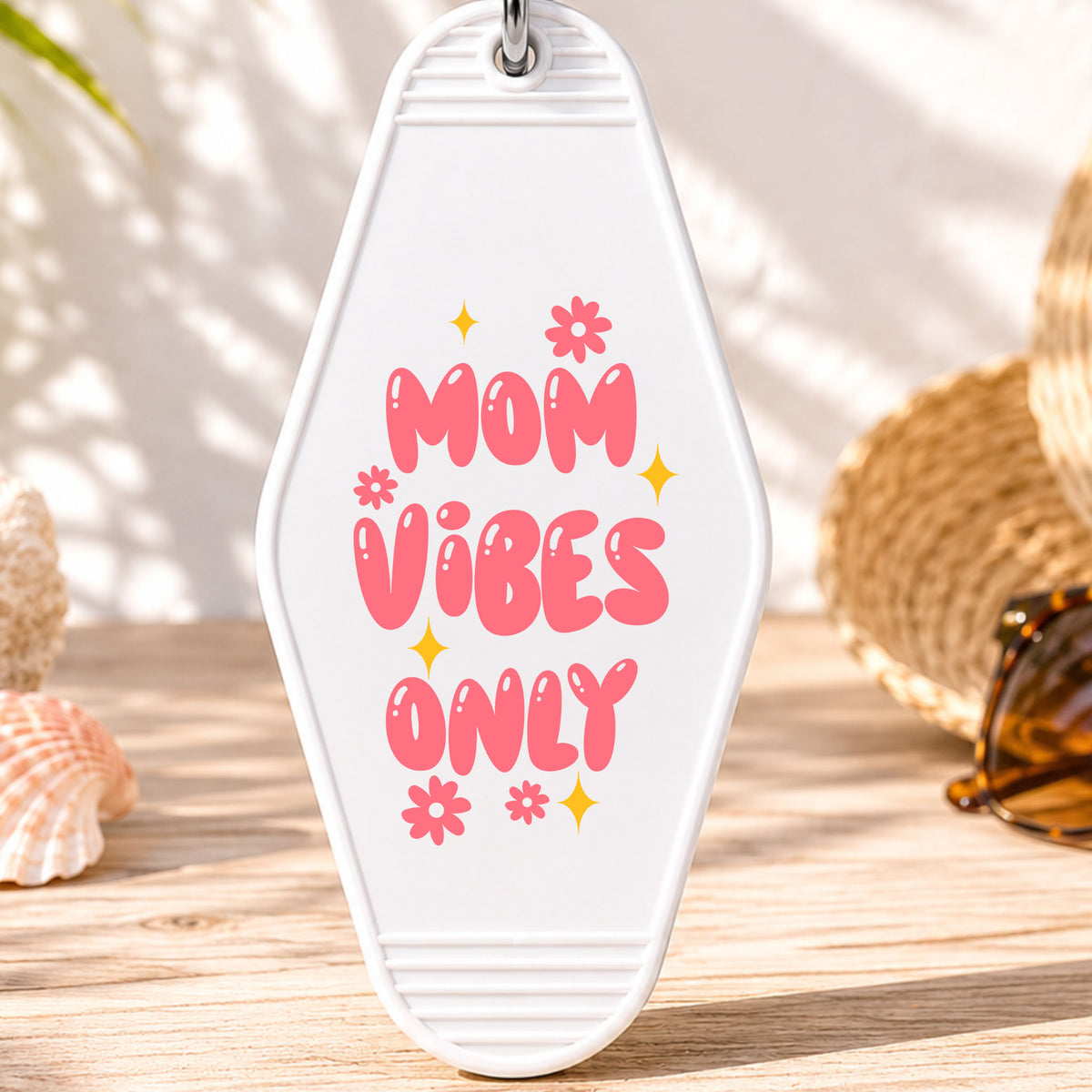 Mom Vibes Only UV DTF transfer on a white motel keychain with beach decor