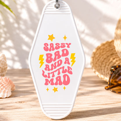 Sassy Bad and a Little Mad UV DTF transfer on a white motel keychain with beach decor