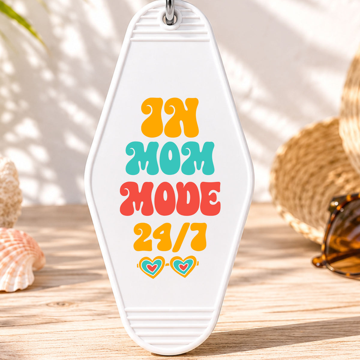 In Mom Mode 24/7 UV DTF transfer on a white motel keychain with beach decor