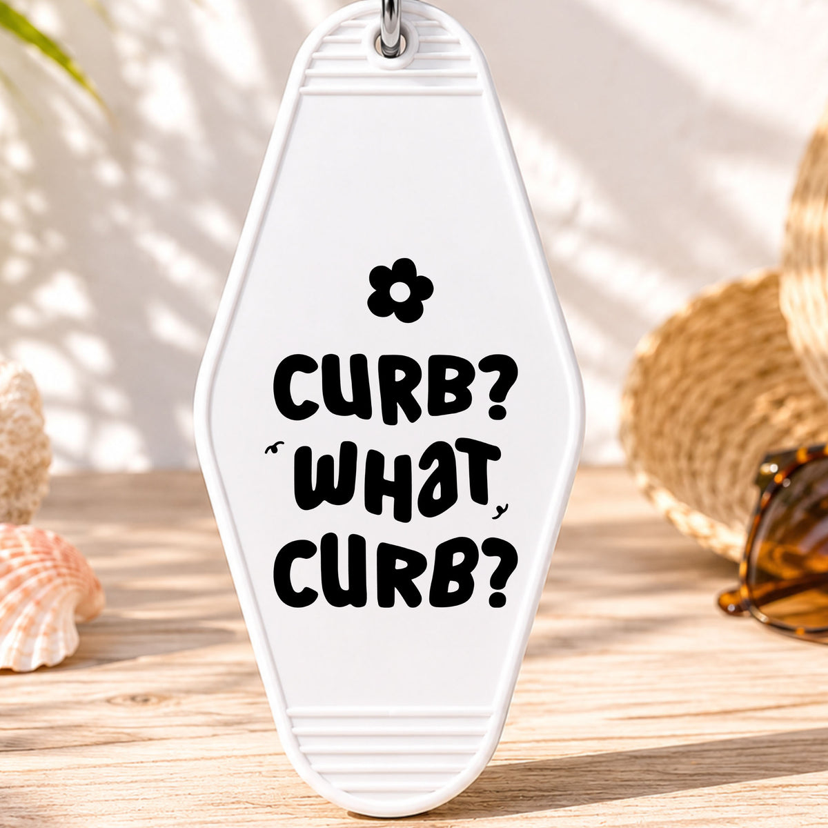 Curb What Curb UV DTF transfer on a white motel keychain with beach decor