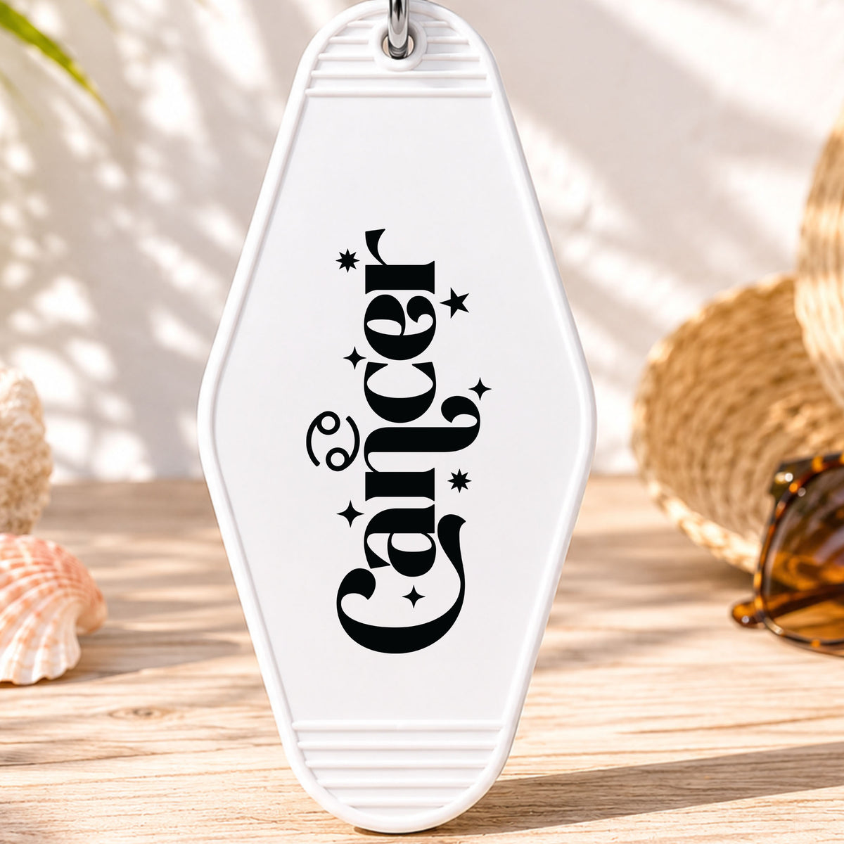 Cancer UV DTF transfer on a white motel keychain with beach decor
