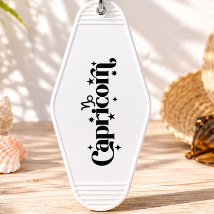 Capricorn UV DTF transfer on a white motel keychain with beach decor