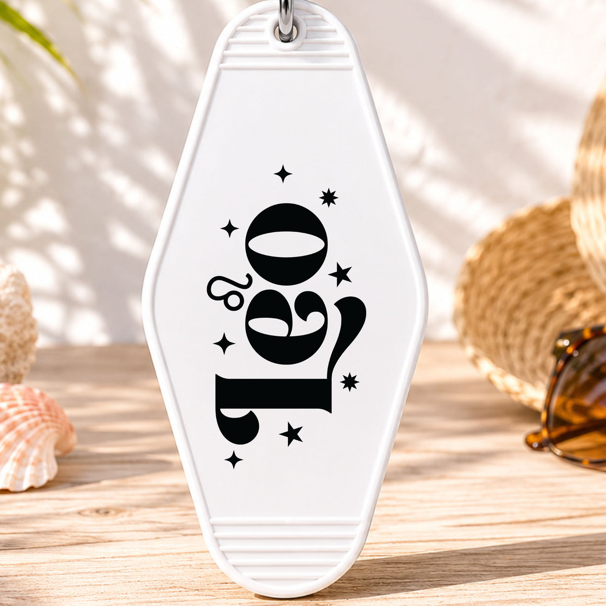 Leo UV DTF transfer on a white motel keychain with beach decor