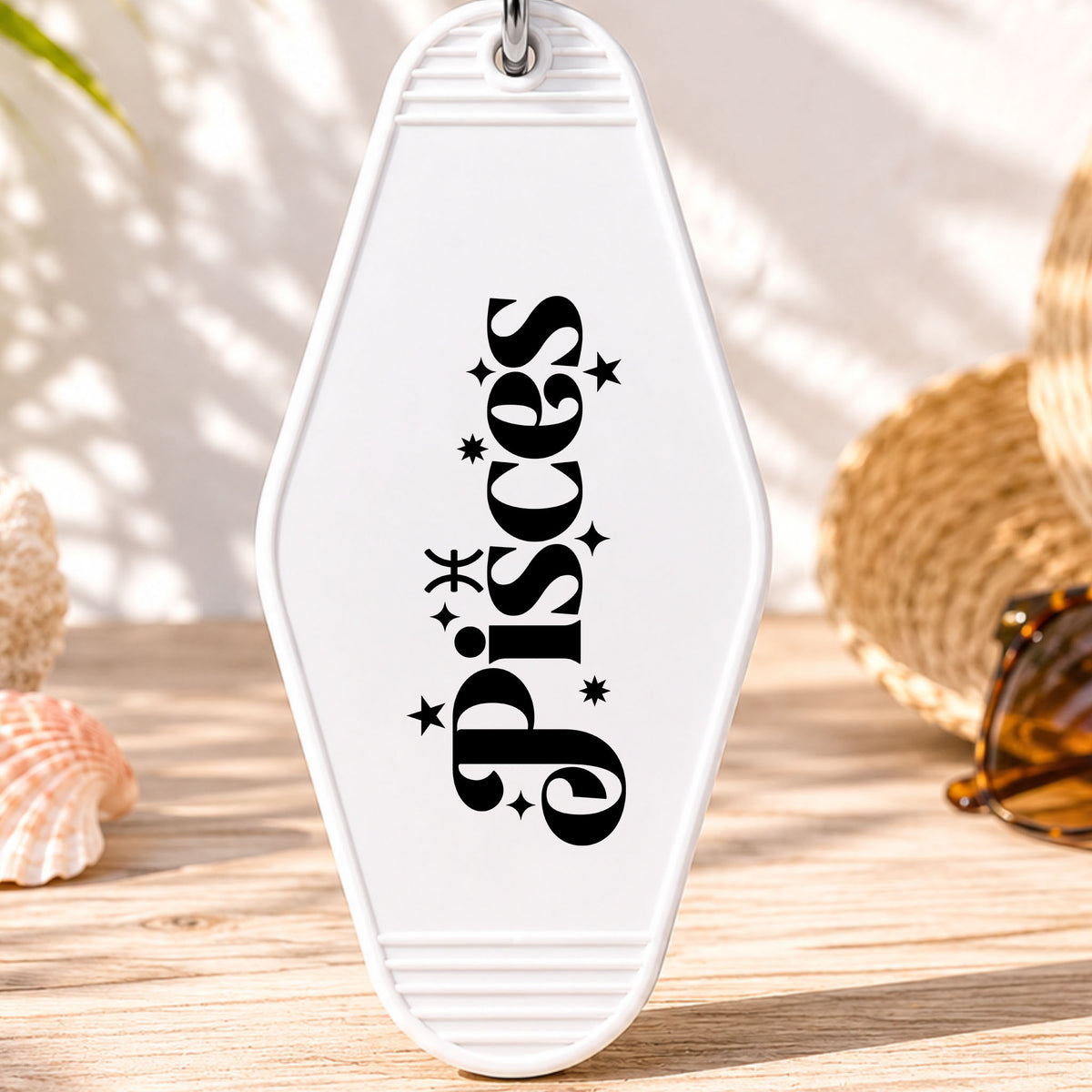 Pisces UV DTF transfer on a white motel keychain with beach decor