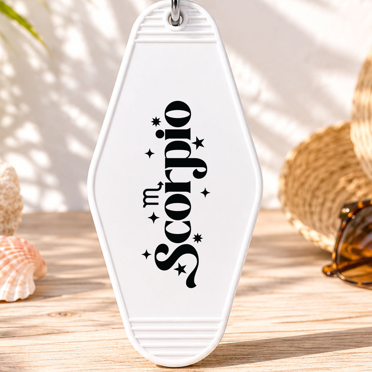 Scorpio UV DTF transfer on a white motel keychain with beach decor