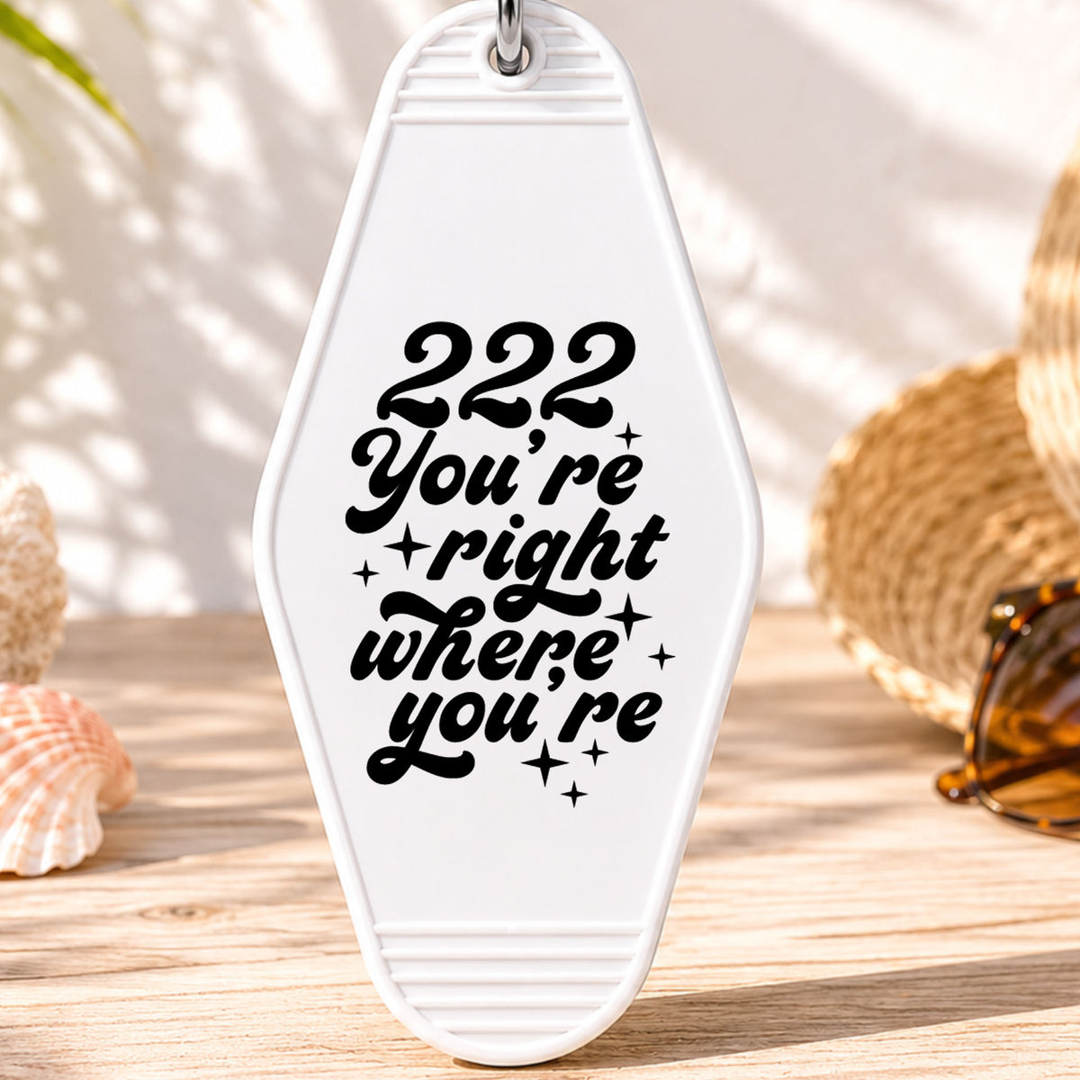 222 You're Right Where You're Meant to Be UV DTF transfer on a white motel keychain with beach decor