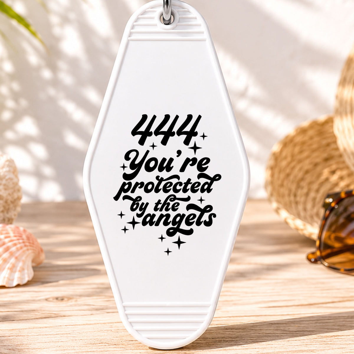 444 You're Protected by the Angels UV DTF transfer on a white motel keychain with beach decor