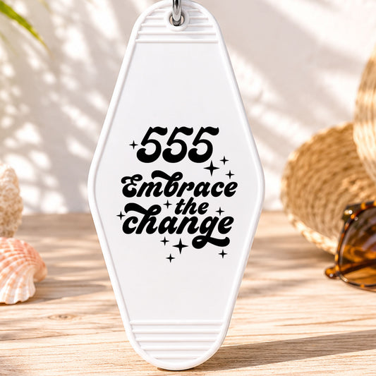555 Embrace the Change UV DTF transfer on a white motel keychain with beach decor