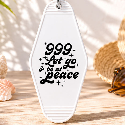 999 Let Go and Be at Peace UV DTF transfer on a white motel keychain with beach decor