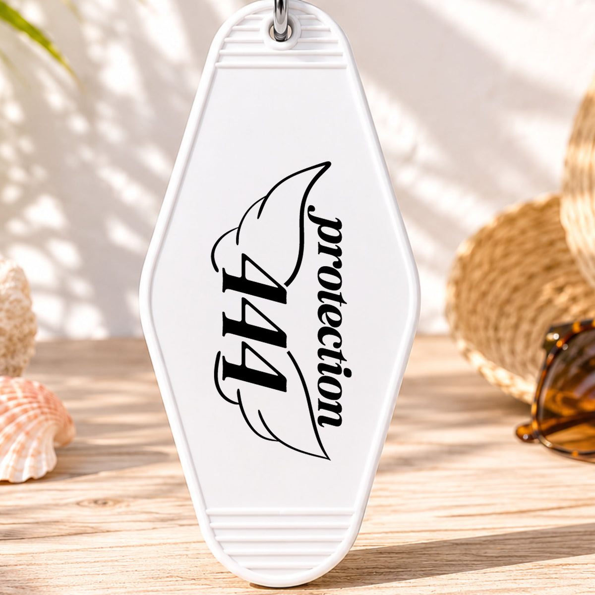 444 Protection UV DTF transfer on a white motel keychain with beach decor