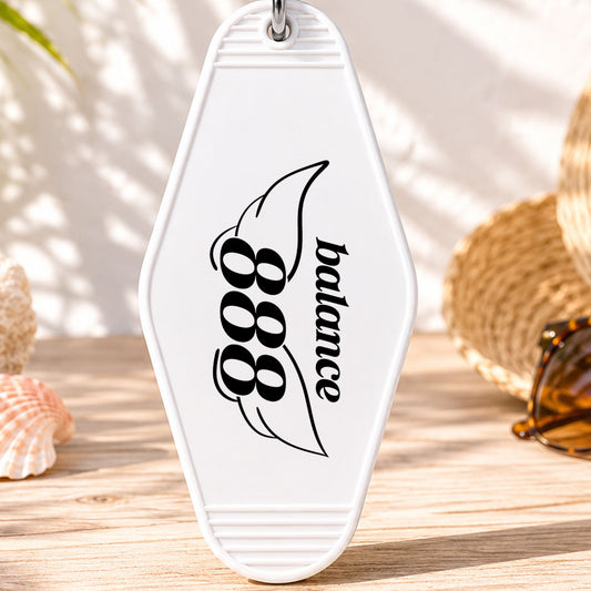 888 Balance UV DTF transfer on a white motel keychain with beach decor