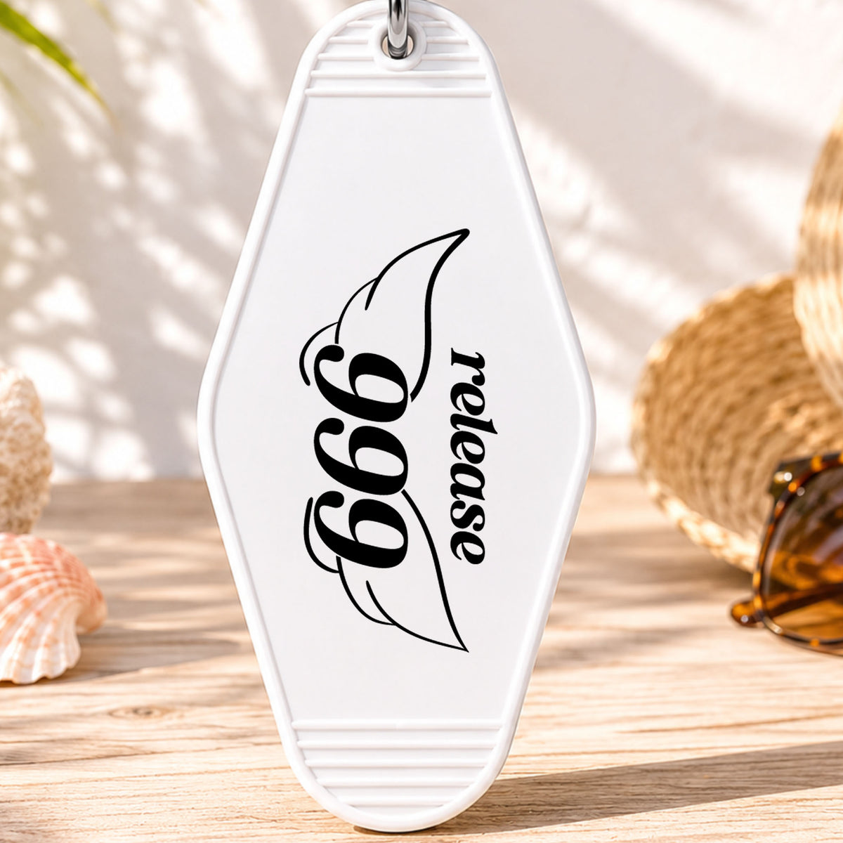 999 Release UV DTF transfer on a white motel keychain with beach decor