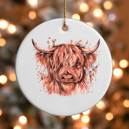 Rose-toned Highland Cow ornament UV DTF transfer on a round white ornament with a bokeh light background