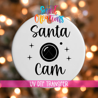 Santa Cam UV DTF transfer on a white ornament with a pink UV DTF Transfer banner and bokeh lights