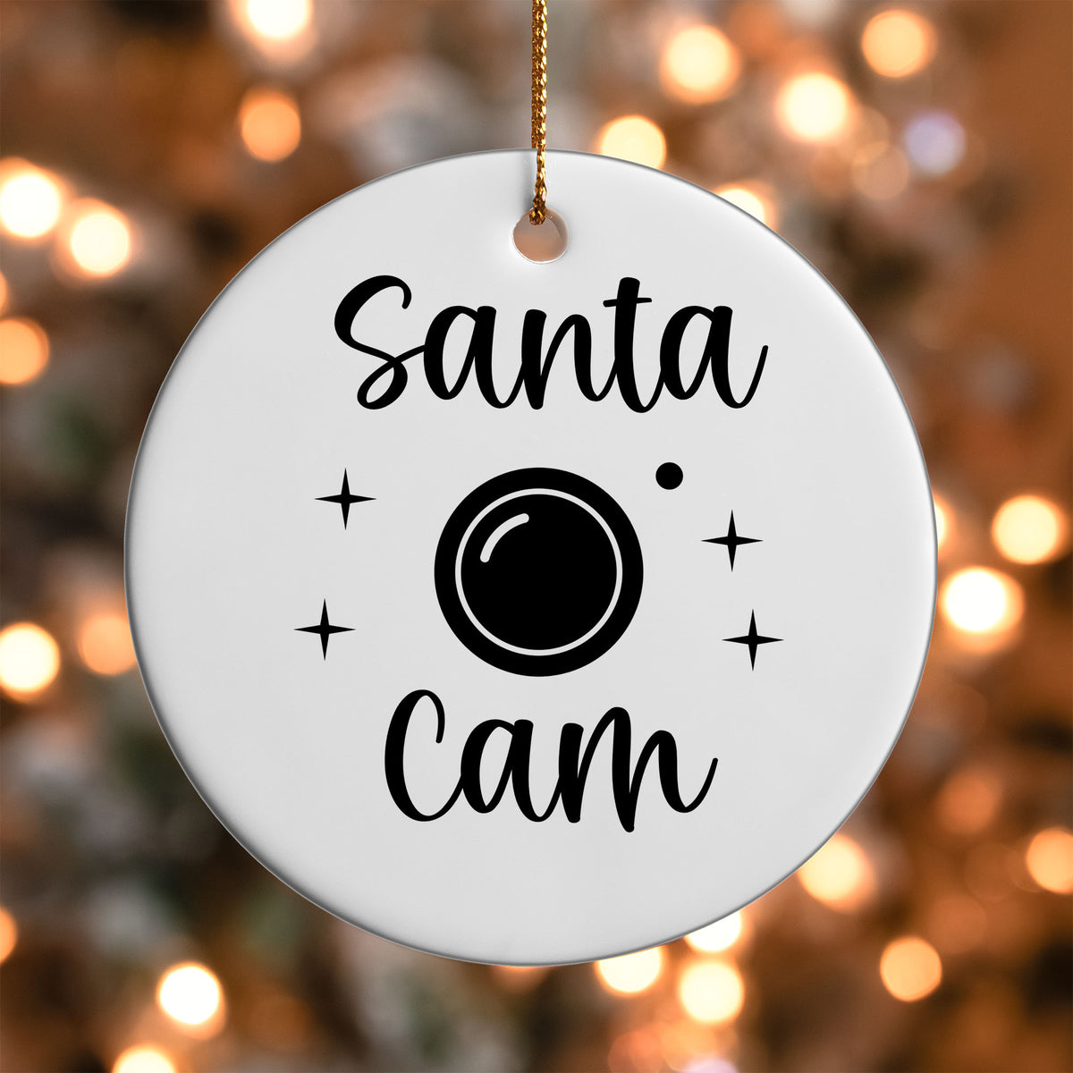 Santa Cam ornament UV DTF transfer on a round white ornament with a bokeh light background