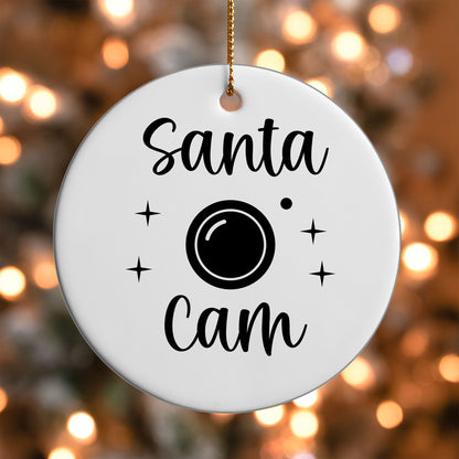 Santa Cam ornament UV DTF transfer on a round white ornament with a bokeh light background