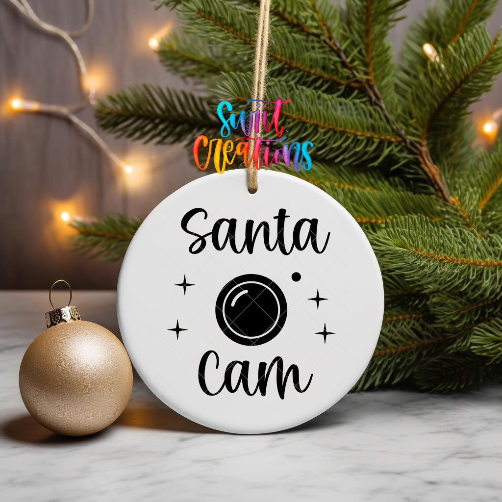 Santa Cam ornament UV DTF transfer on a hanging ornament with pine branches and a gold bauble