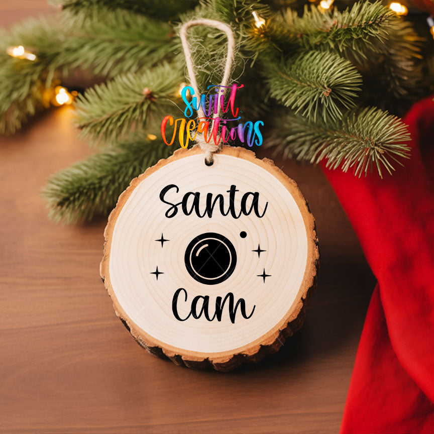 Santa Cam UV DTF transfer on a wood slice ornament with pine branches and a red stocking